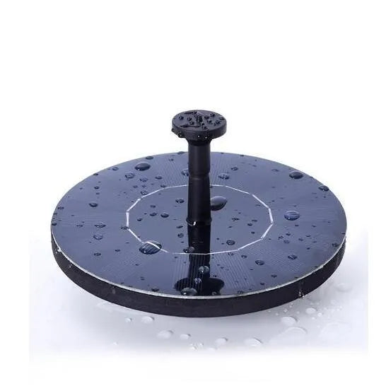 Black solar-powered water fountain pump with four spray nozzles, placed in a birdbath.