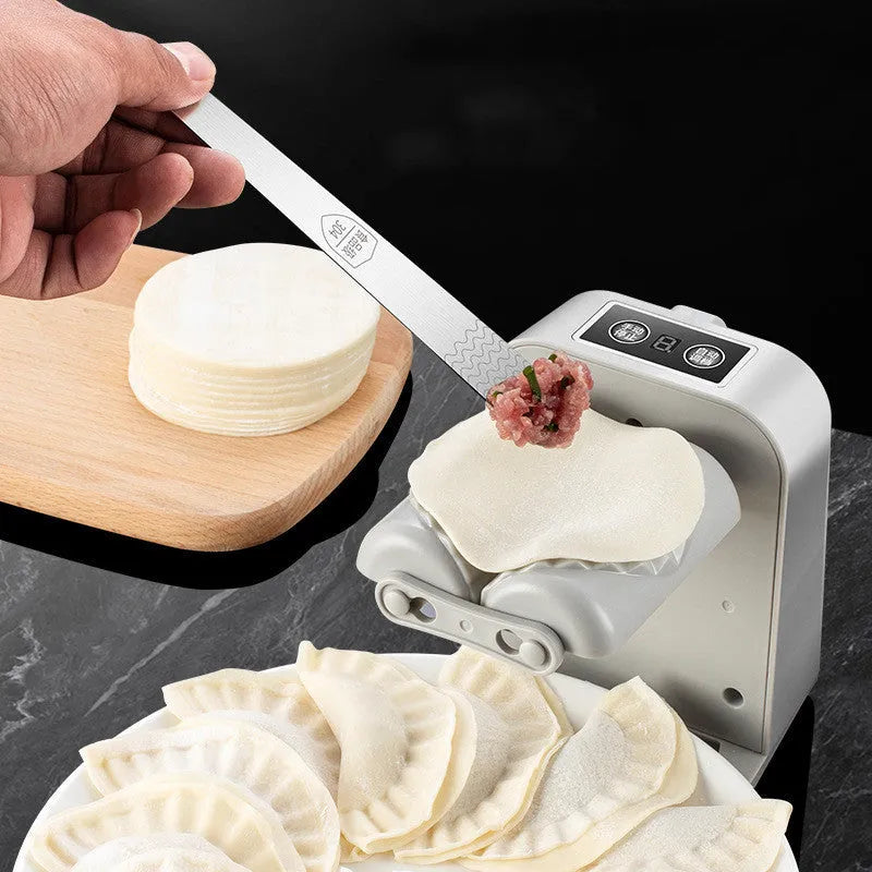 White electric dumpling maker machine with modern design on kitchen countertop