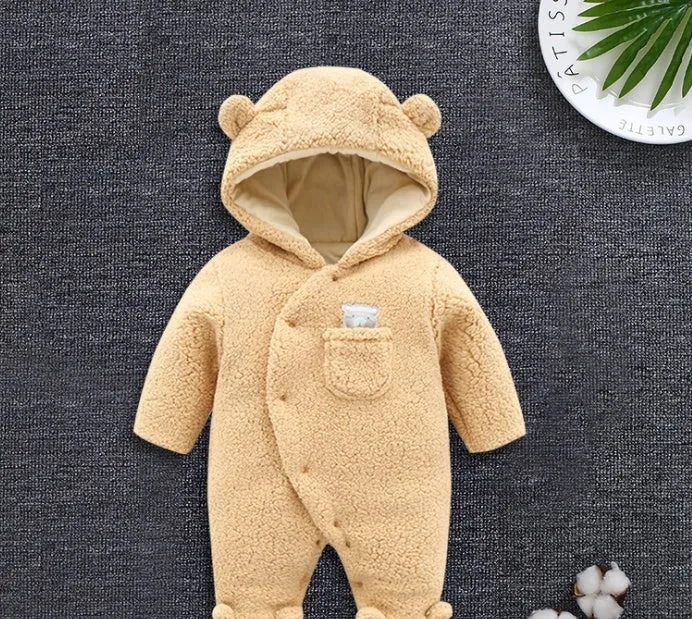 Baby wearing white cotton padded romper with lamb design and feet covers