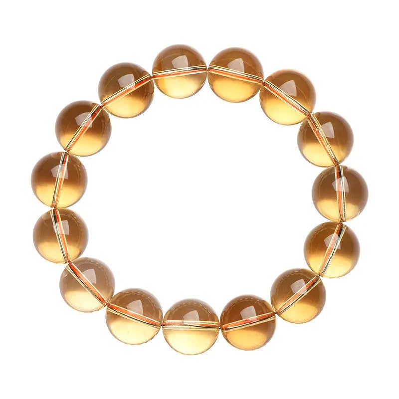 Handmade natural citrine scattered beads ball bracelet on a wrist, showing polished yellow gemstones.