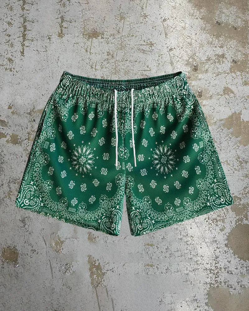 Man wearing loose-fitting digital print beach shorts in a contemporary colour, showing the elastic waistband and quick-dry milk silk fabric.