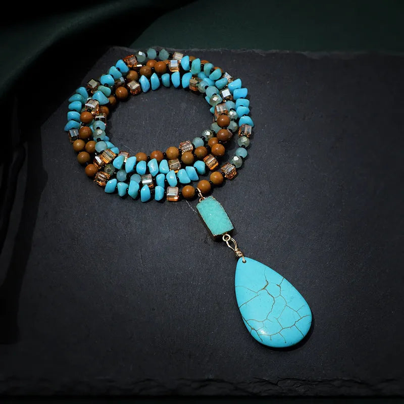 Turquoise heart-shaped water drop pendant necklace with blue gem inlaid detailing on geometric ball bead chain
