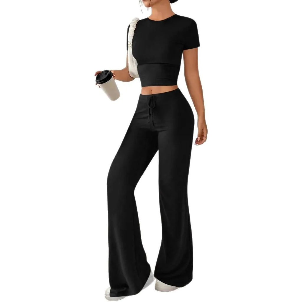 Black high-waist trousers and matching short-sleeve t-shirt set on a hanger.
