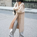 Long grey knitted hooded cardigan coat with a trench coat style, shown open.