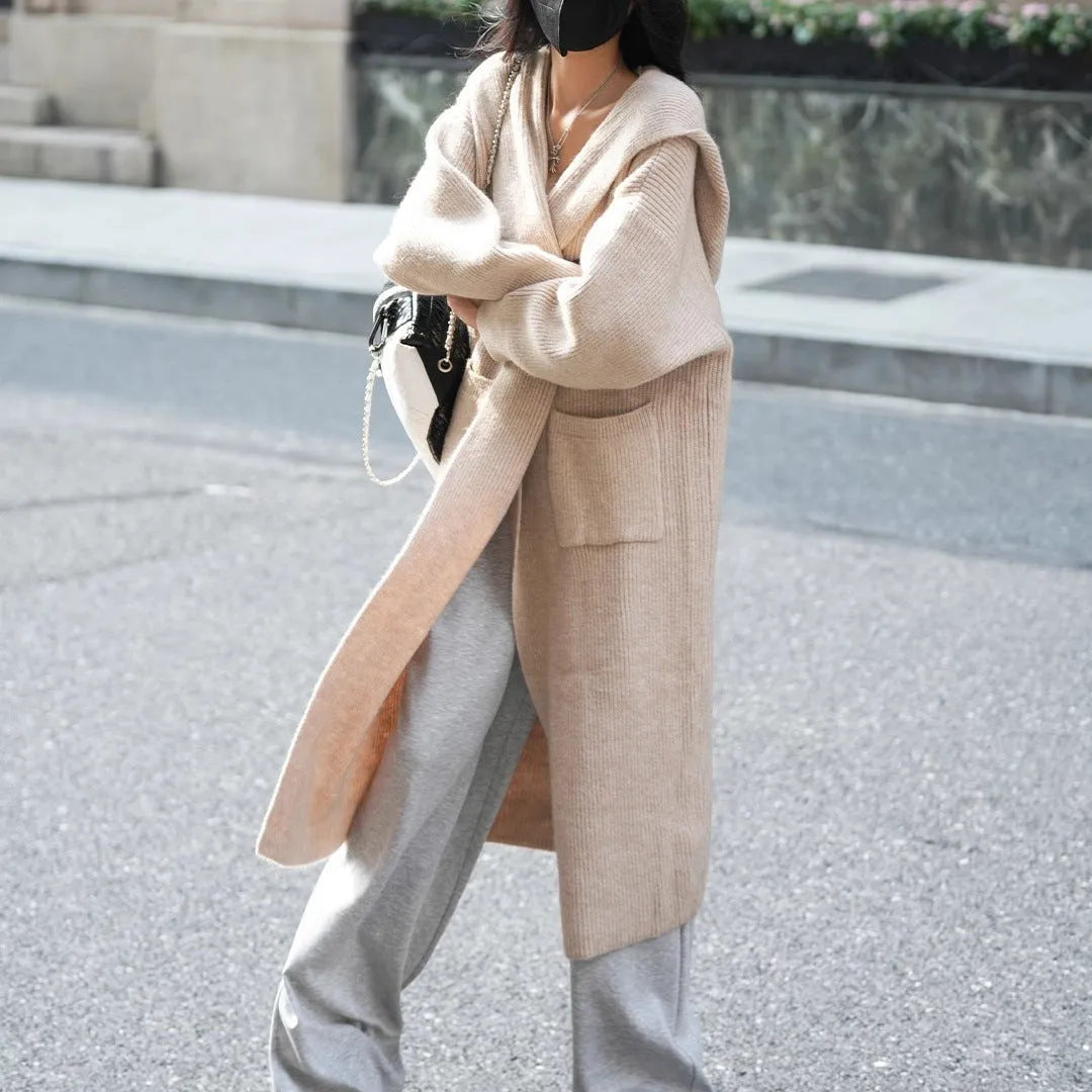 Long grey knitted hooded cardigan coat with a trench coat style, shown open.