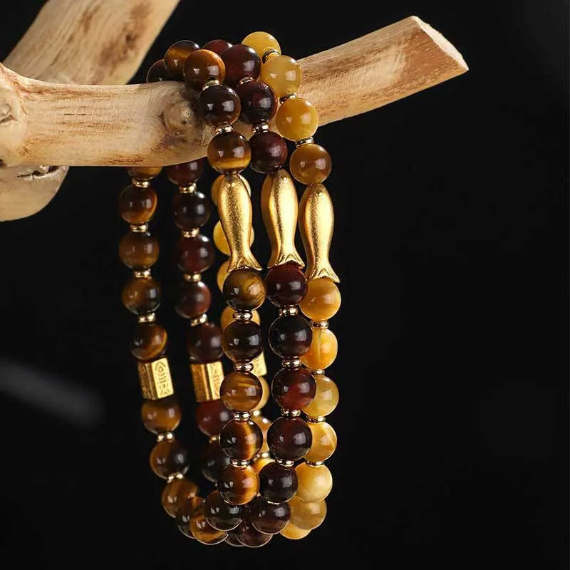Handmade women's bracelet with tiger eye gemstone beads carved into small fish designs