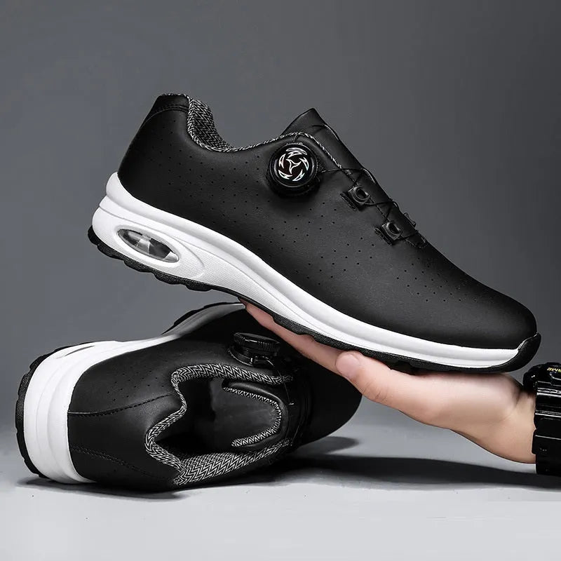 Black and white low top mesh casual shoes with lace-up front and cross shoulder straps on a composite sole.