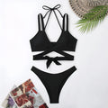 Women's solid colour strap bikini swimsuit in brief style on a white background.