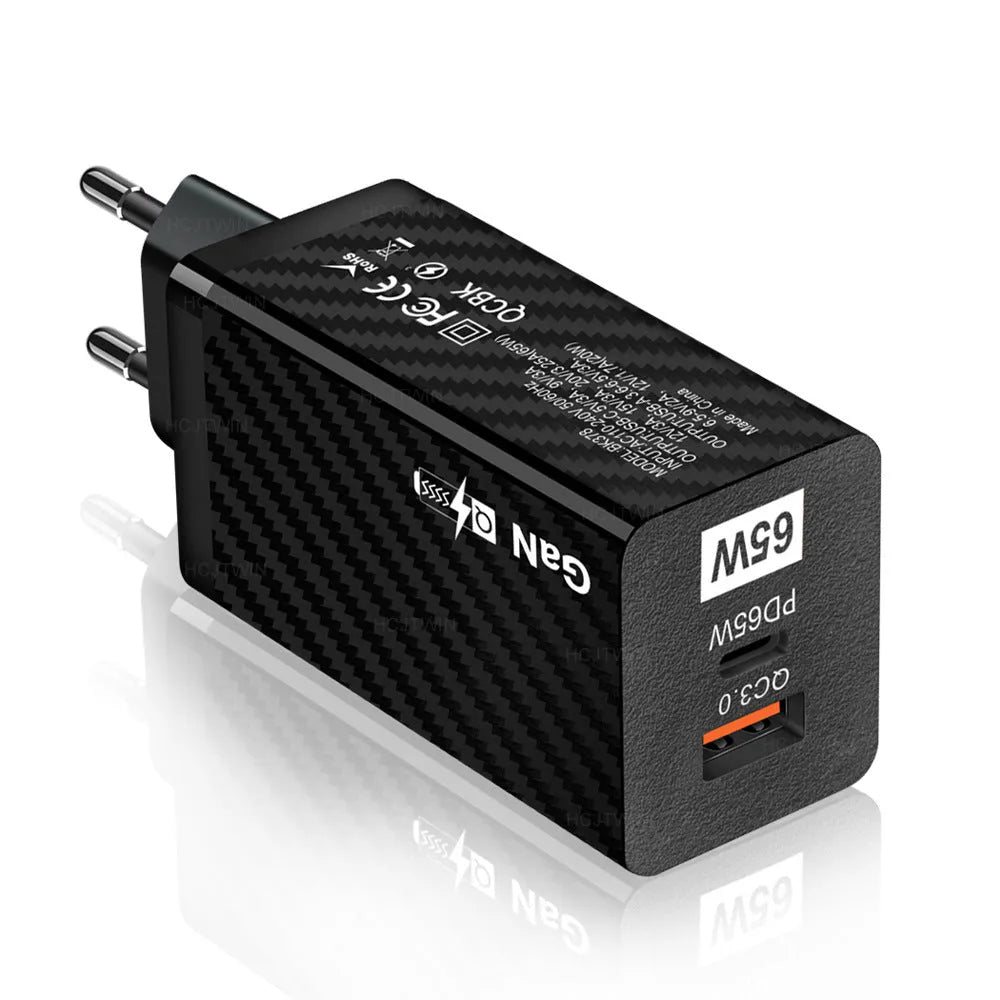 Compact white 65W Gallium Nitride laptop charger with USB-C port next to EU and US plug options.