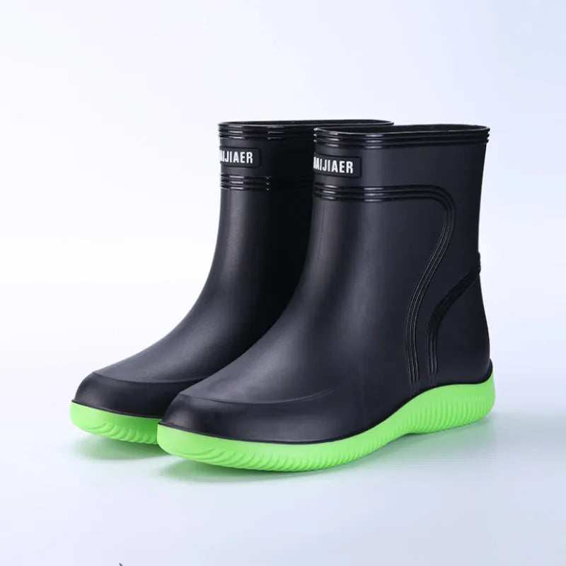 Men's mid-top PVC rain boots in black with green detailing, tassel decoration, and non-slip sole