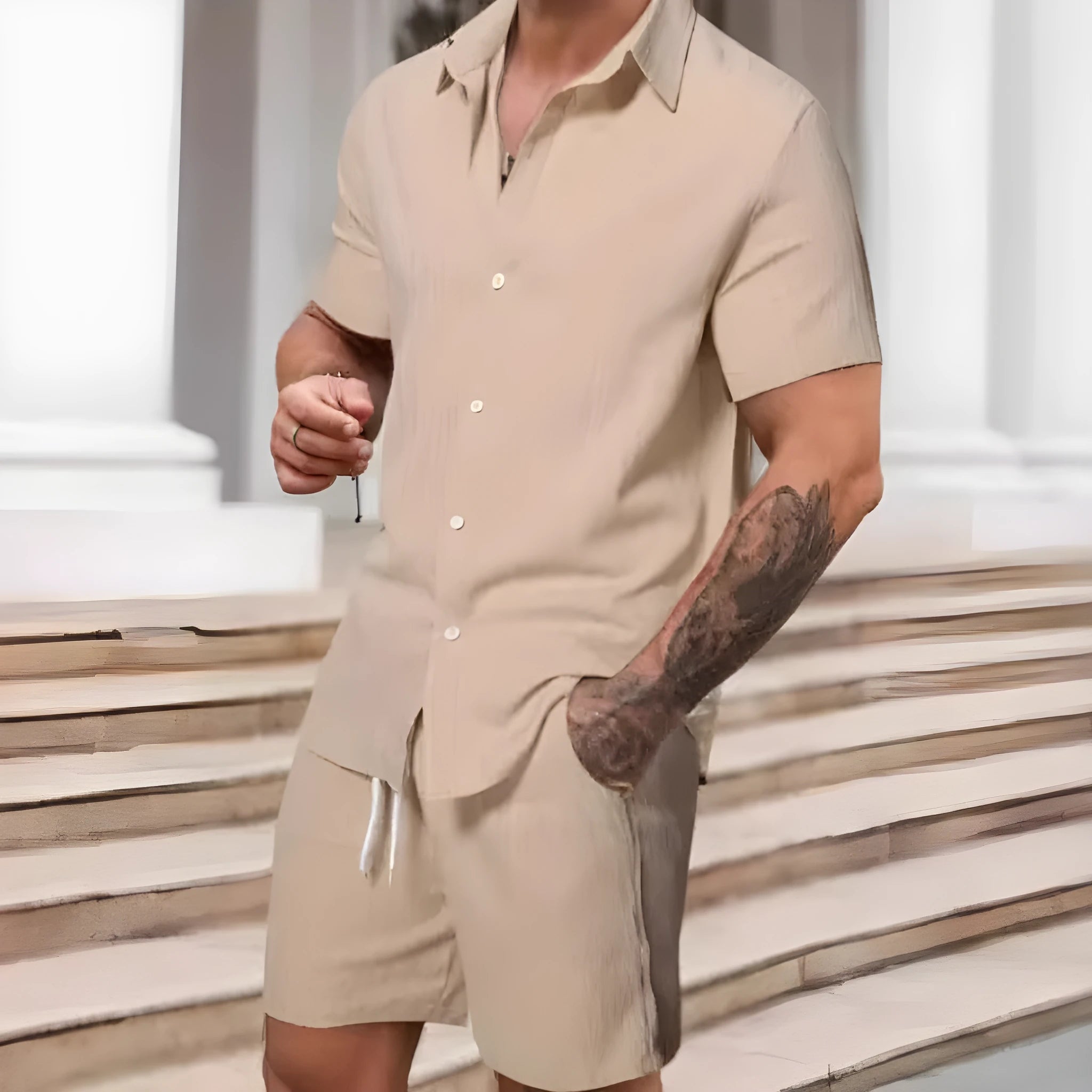 A man wearing a striped short-sleeve shirt and matching shorts from a casual suit set.