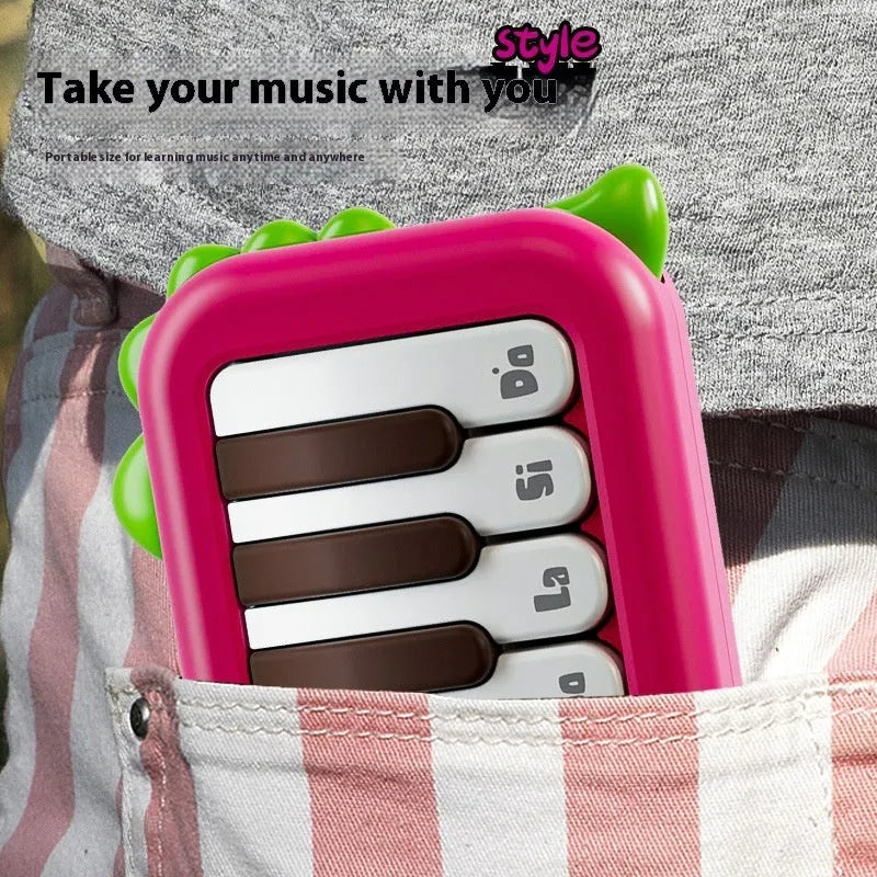 Pocket electronic keyboard toy for children in green or pink, plays little piano patterns for developmental training.