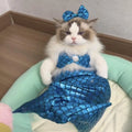 Blue mermaid costume on a cat showing the long glittering fishtail and elastic chest strap.