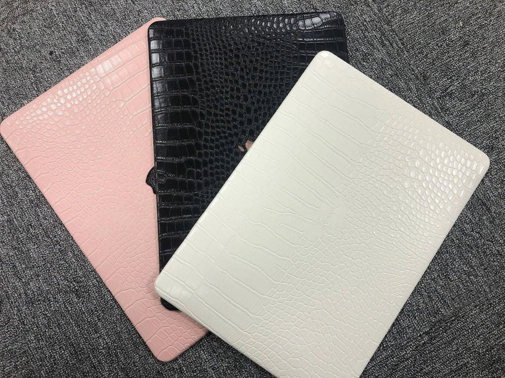MacBook protective case with crocodile pattern texture and hollowed-out Apple logo design in black colour