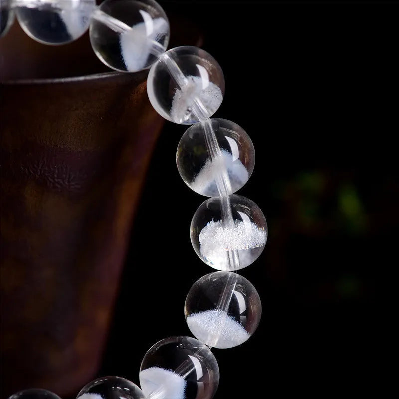 Women's white crystal bracelet with a ghost pyramid centrepiece and a traditional Ruyi charm.