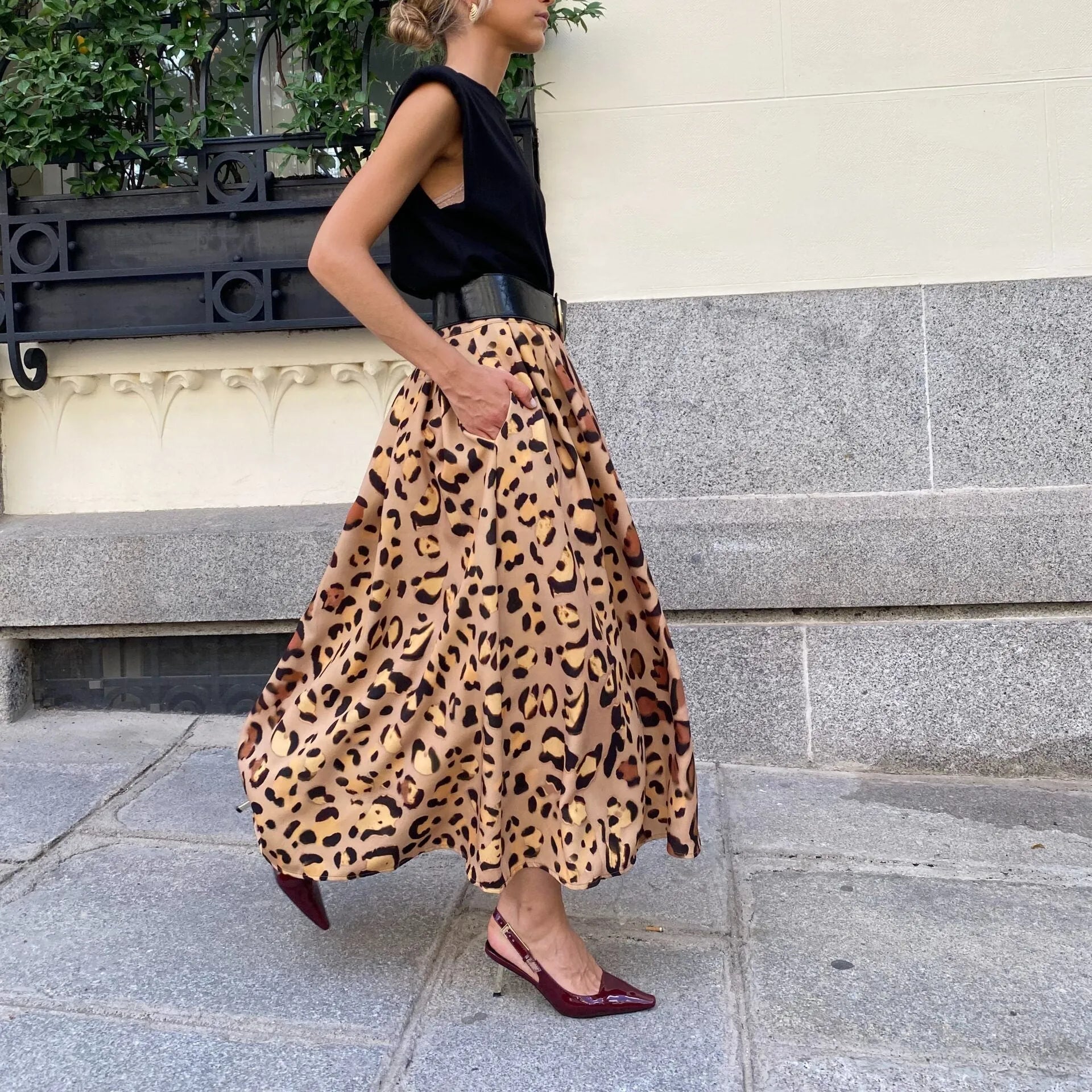 Brown leopard print women's A-line long skirt with a big hem on a model.