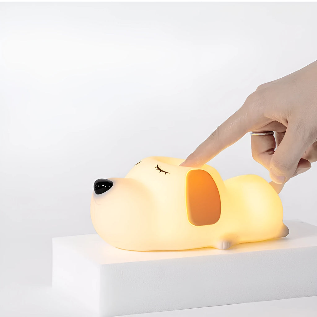 Small two-tone cartoon dog shaped silicone night lamp with USB charging port.