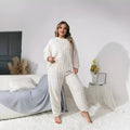 Women's milky white polyester two-piece pants suit with crew neck top and matching trousers