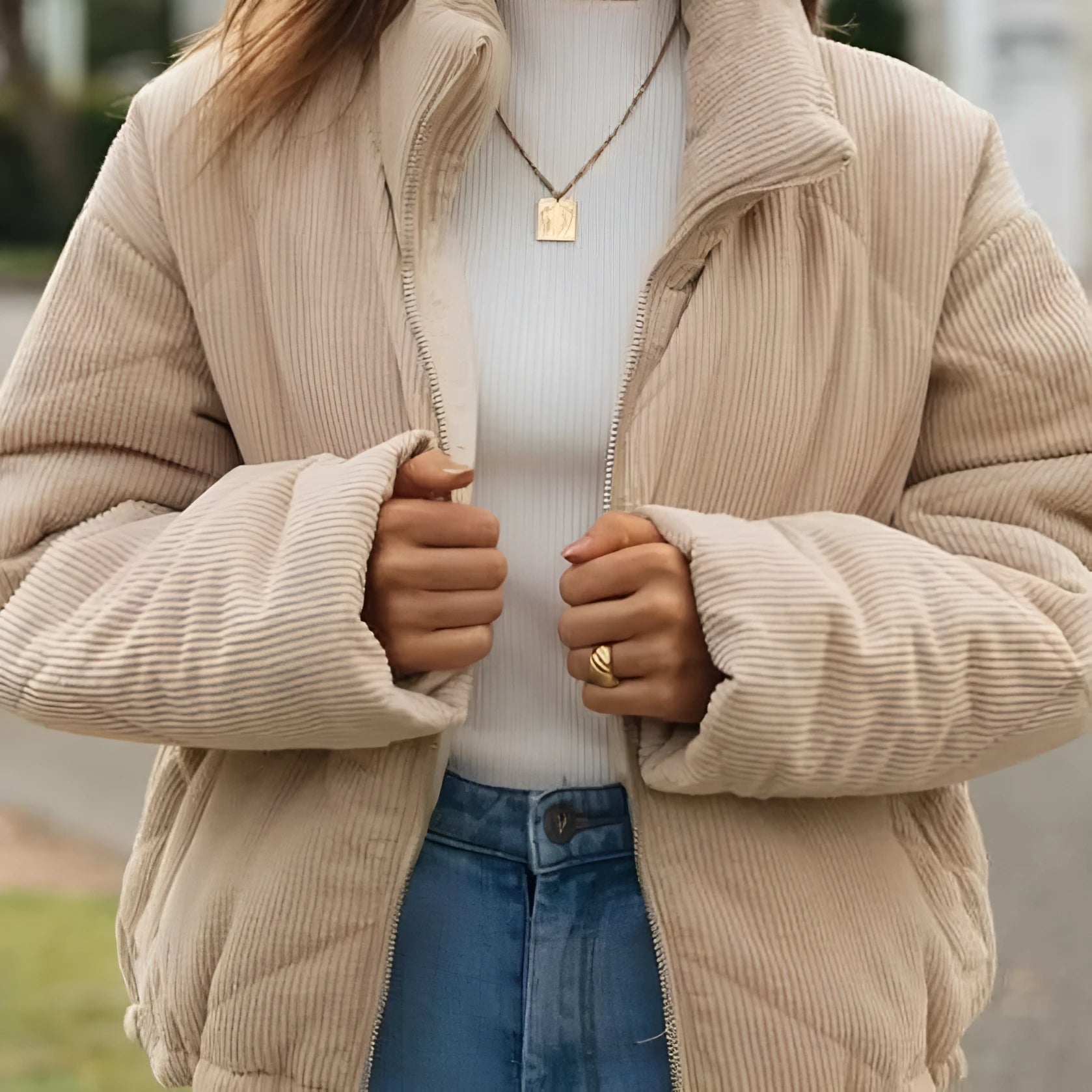 Women's apricot corduroy jacket with stand collar and front zipper on mannequin