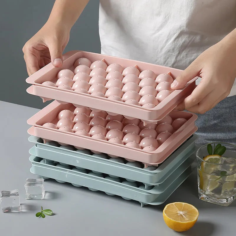 Sky blue and pink 3D round ice cube moulds with spherical cavities