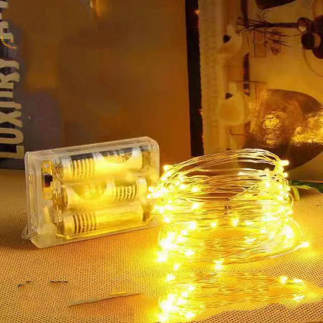 12-metre long copper wire LED string lights with 120 bulbs and a battery box, shown in a selected colour.