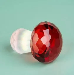 Colourful geometric mushroom crystal decorative ornament in transparent, green, red, or yellow.