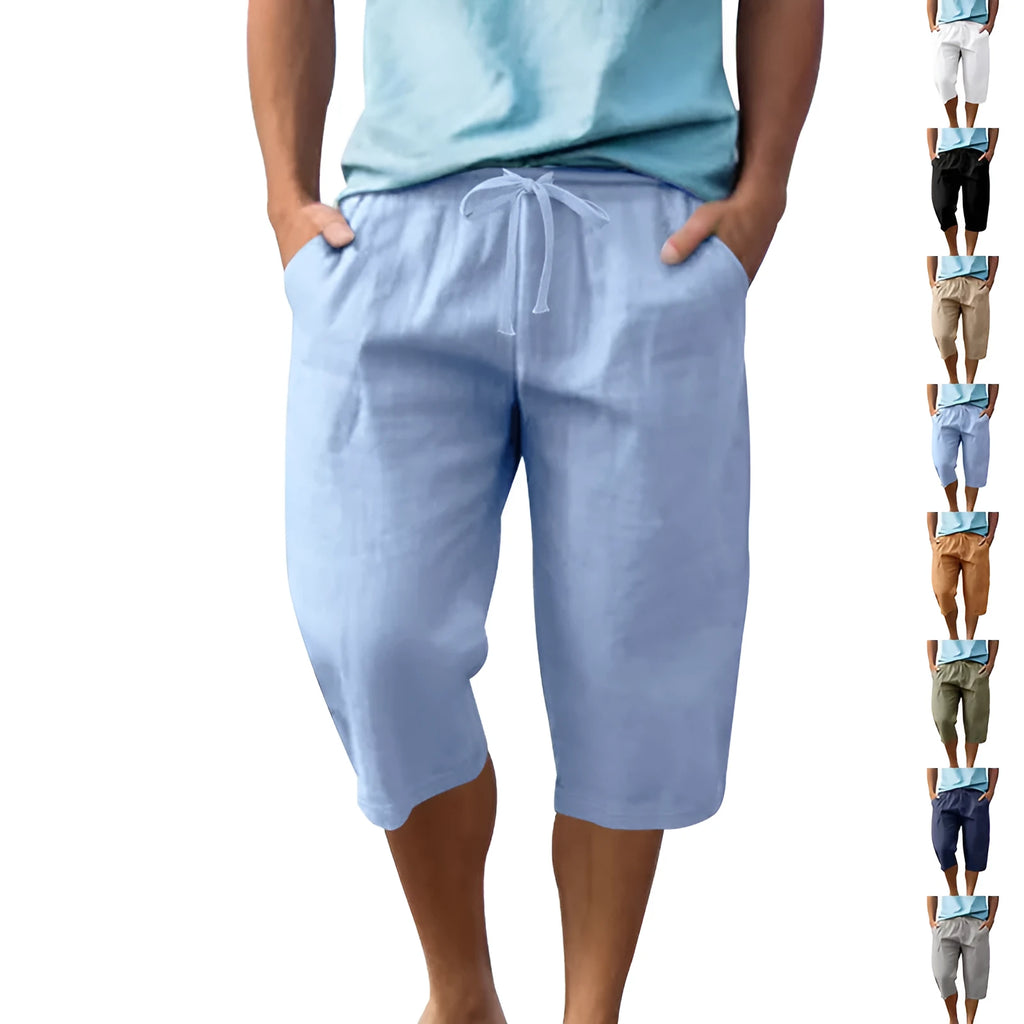 Men's light khaki linen shorts with a drawstring waistband and loose, cropped leg fit.