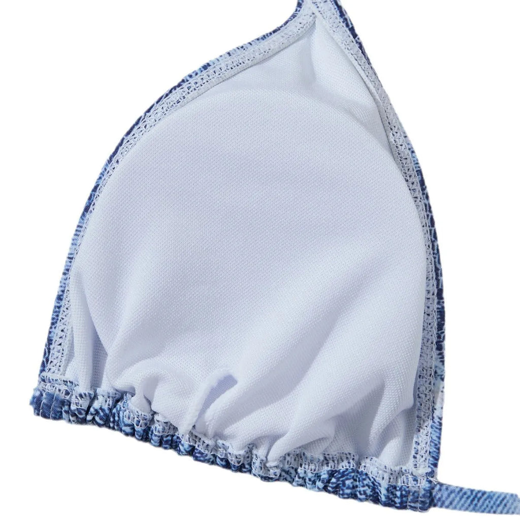 Denim blue printed women's bikini set with strap design on a mannequin, showing top and bottom.