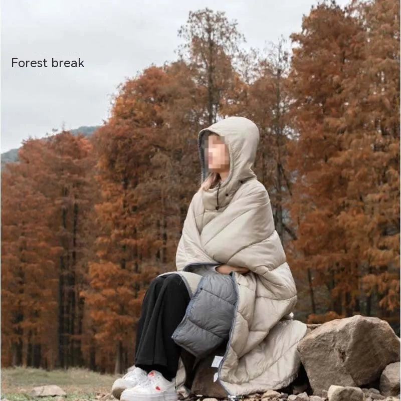 Outdoor wearable cloak sleeping bag in army green or grey, shown as a blanket and cape.