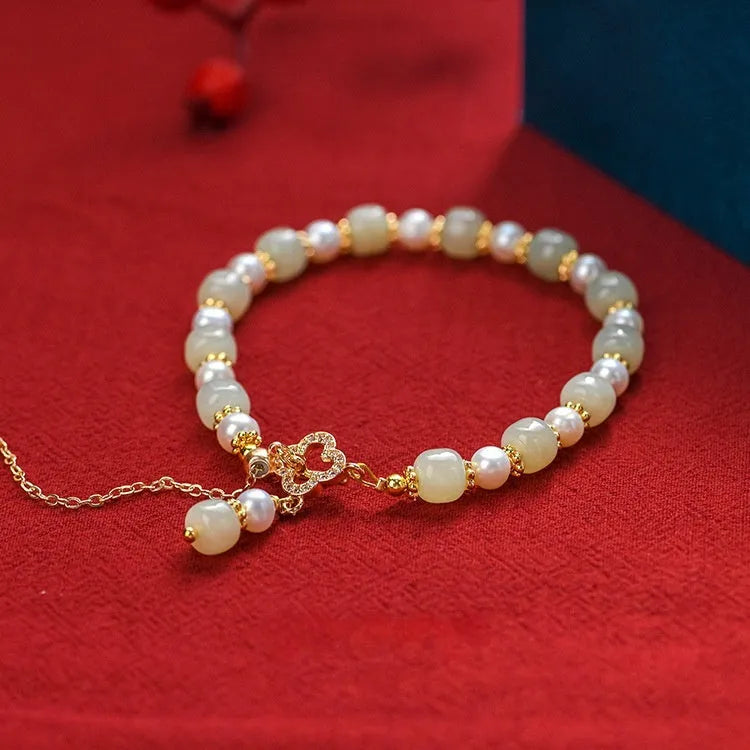 Women's bracelet with round Hetian jade pendant on gold-tone electroplated chain, Chinese-style design