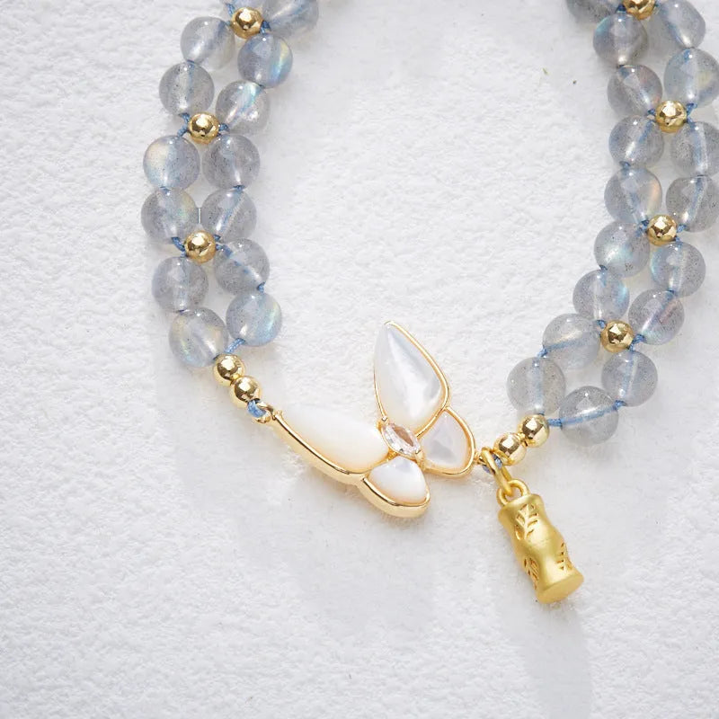 Gray moonstone woven bracelet with geometric design on woven hand rope