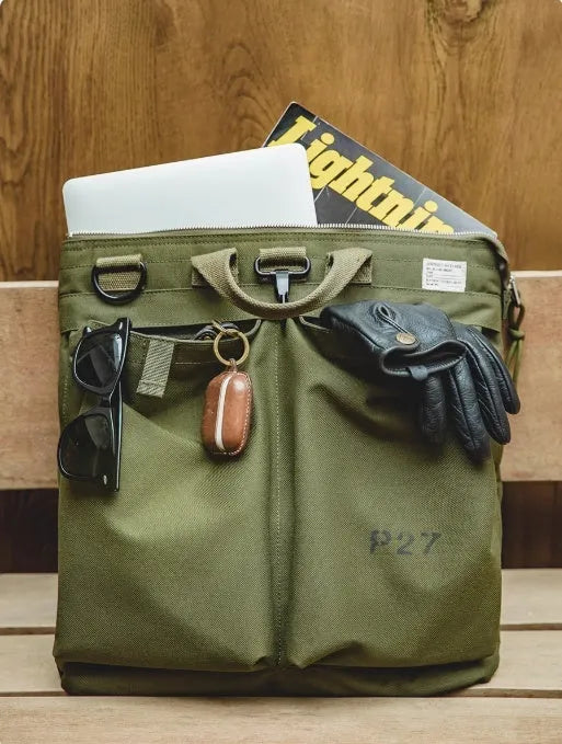 Military green canvas crossbody messenger bag with shoulder strap showing vertical square shape and zipper closure