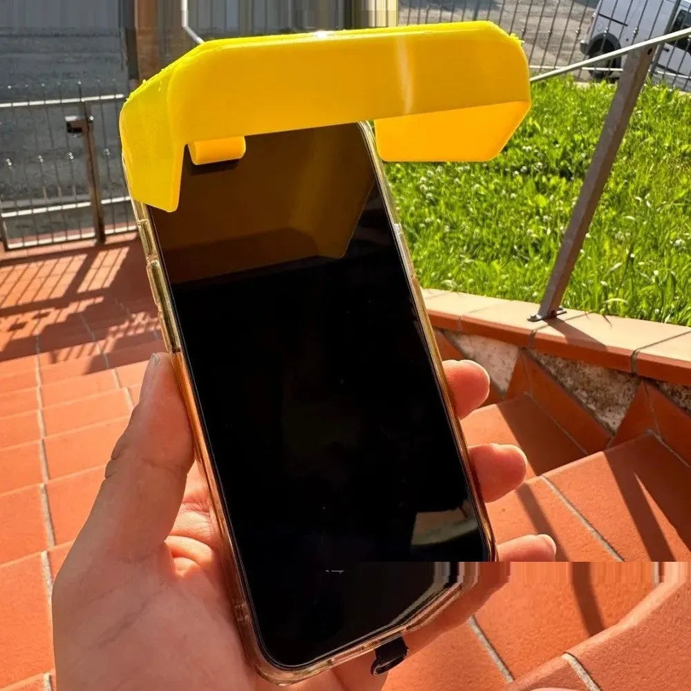 Yellow and black plastic phone sunshade with a clip for attachment to smartphones outdoors.