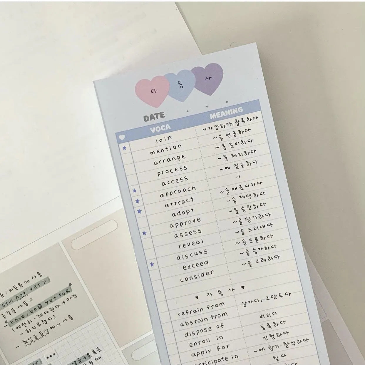 Vertical format English vocabulary notepad in B5 half size showing pink cover and double-sided printed pages