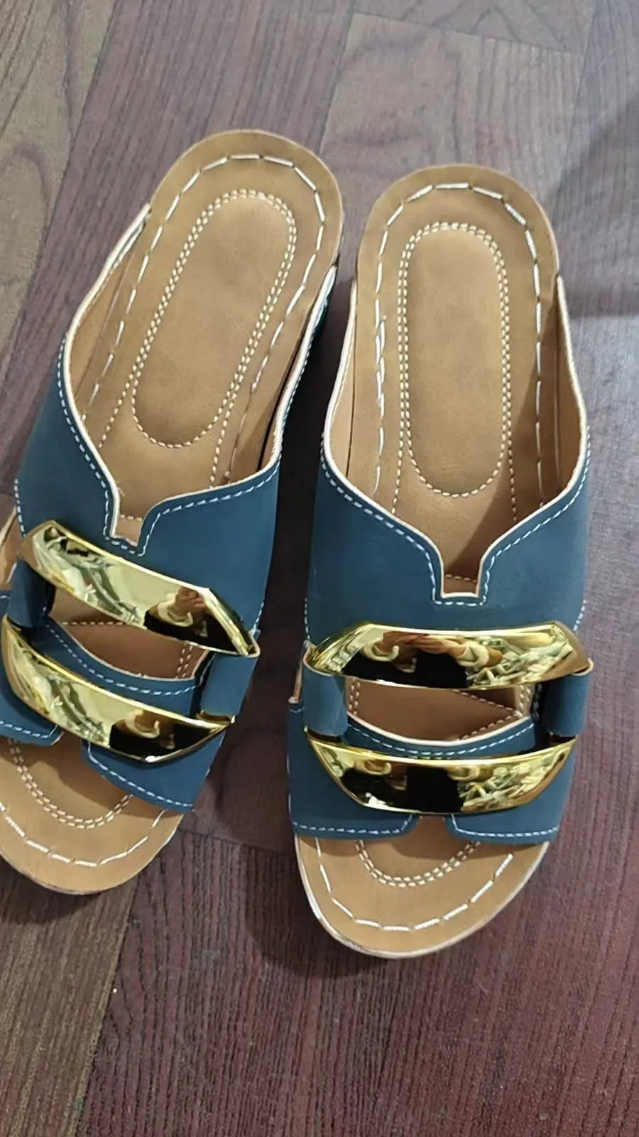 Roman style platform sandals in black, featuring a flat heel, rubber sole, and metallic decorative details.