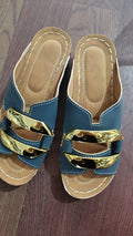 Roman style platform sandals in black, featuring a flat heel, rubber sole, and metallic decorative details.
