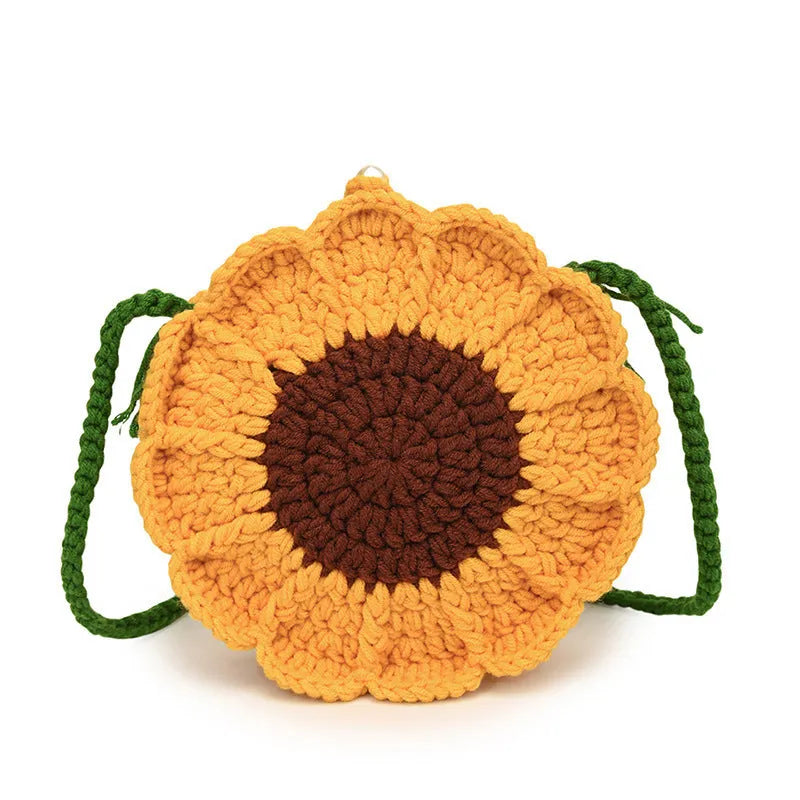 Hand-woven wool crochet bag with flower detailing and round suitcase shape showing internal mobile phone pocket