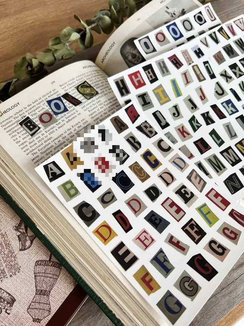 Set of cute style printed decoration stickers showing English letters, numbers, symbols, and weekly words.
