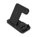 Black four-in-one wireless charging pad for mobile phones with included QC3.0 charging head.