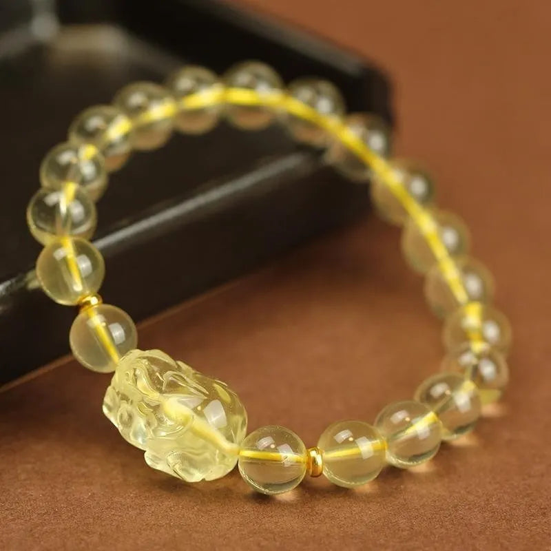 Simple yellow leather cord bracelet with a faceted citrine-coloured artificial crystal pi xiu bead.