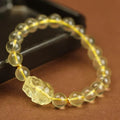 Simple yellow leather cord bracelet with a faceted citrine-coloured artificial crystal pi xiu bead.