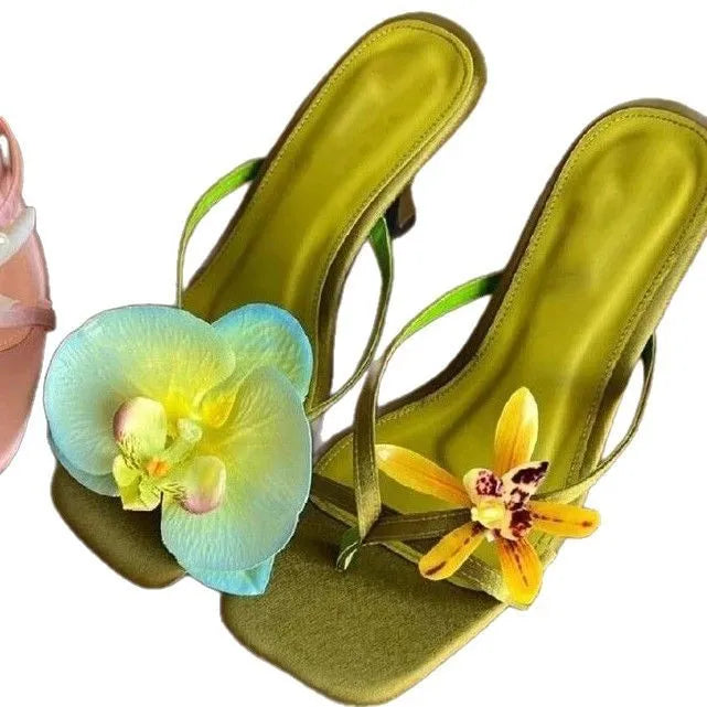 Women's handmade asymmetric flower design sandals with a high heel in calf leather.