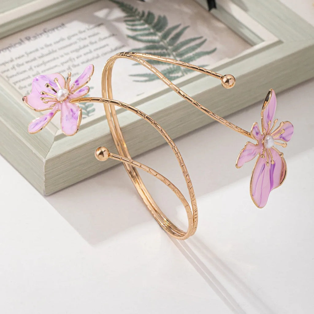 Close-up of a pink alloy fashion arm ring with a hollow armband lines pattern design.