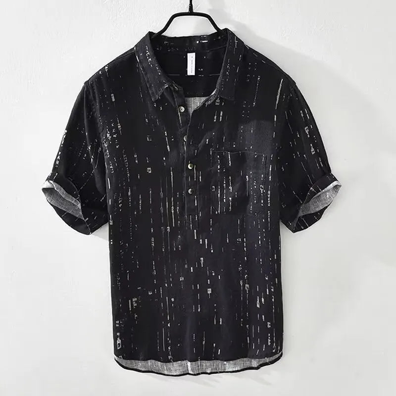Man wearing a black loose-fit lapel polo shirt, short sleeves, casual summer style.