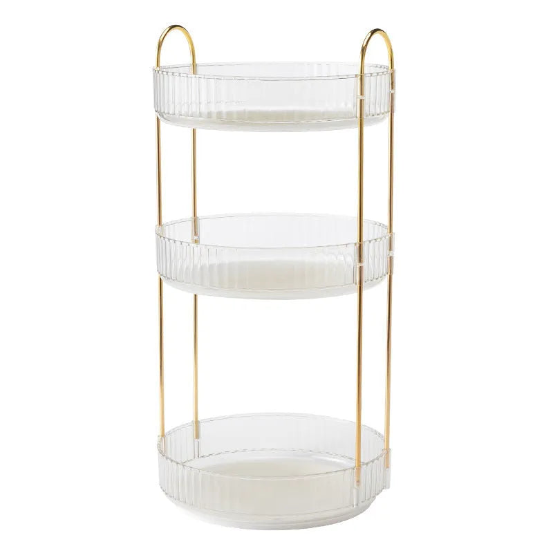 Three-layer rotating bathroom cosmetics storage rack in green on a desktop, with bottles on each tier.