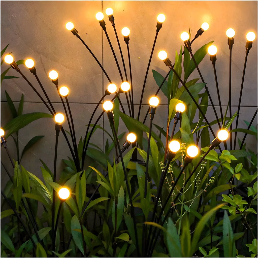 Solar-powered LED garden stake light with multiple heads on a stainless steel spike, showing warm white and coloured light modes.