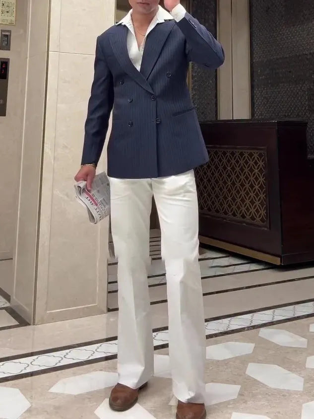 Men's classic striped double-breasted polyester blazer on a hanger, showing regular fit and length.