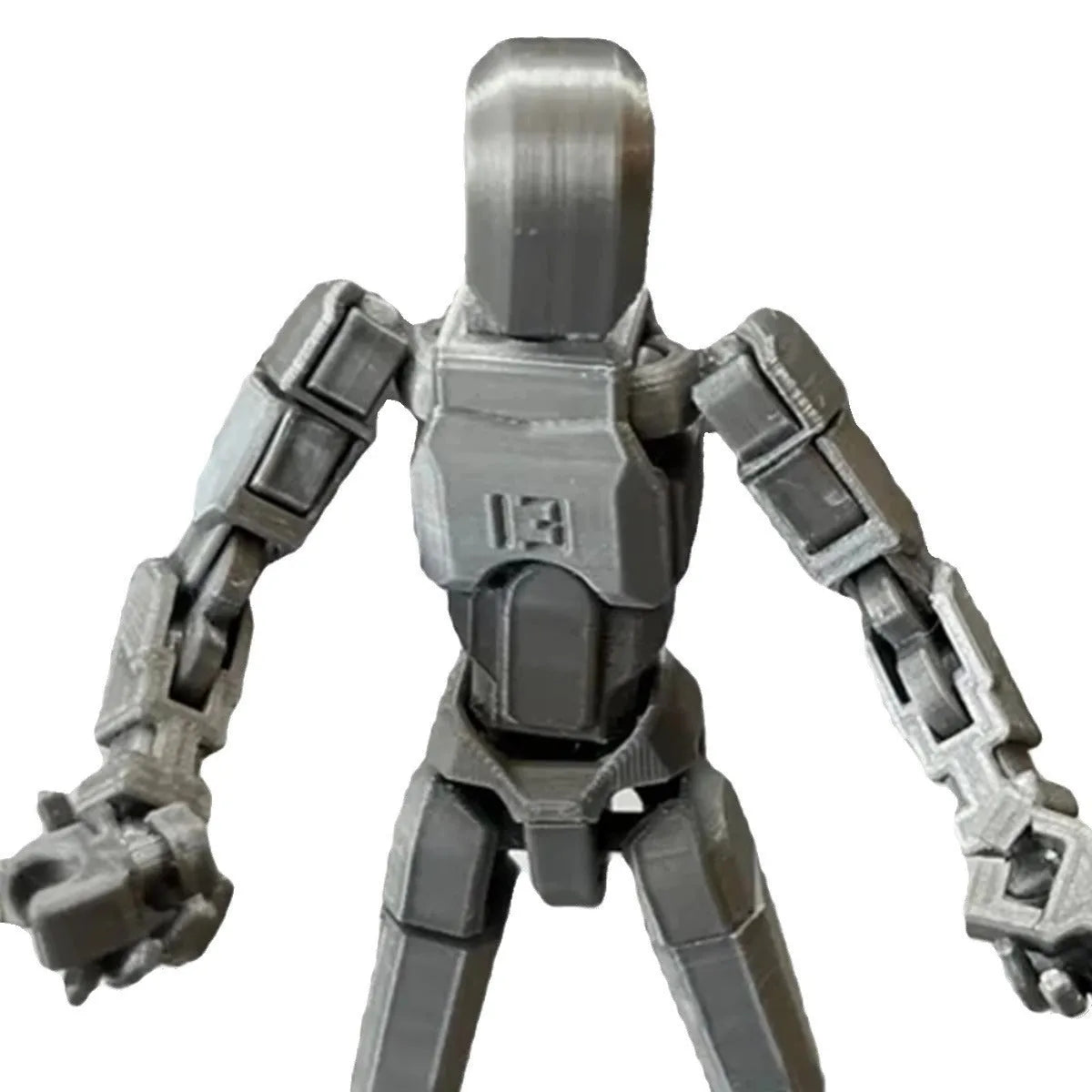 Unassembled 3D printed robot model kit with multi-jointed parts on a table
