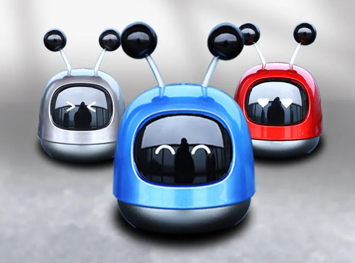 Robot-shaped car vent air freshener ornament in blue, grey or red with gel fragrance.