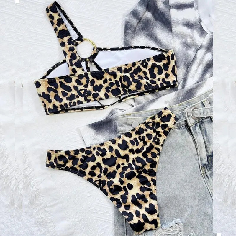 Women's leopard print and polka dot bikini set with top and shorts on a mannequin.